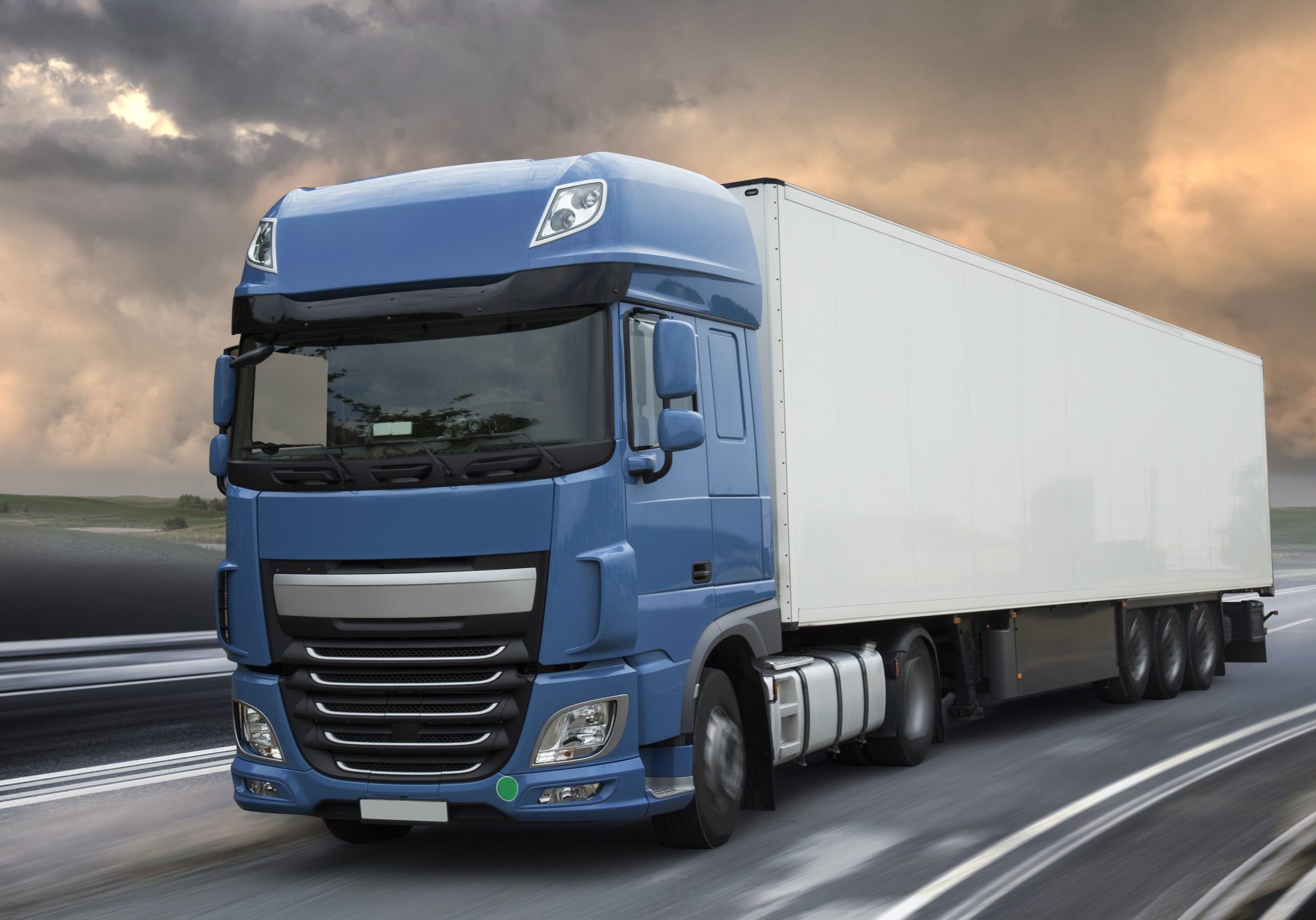 Blue New 2016 Lorry big truck in motion on grunge road with sky in background, isolated with clipping path